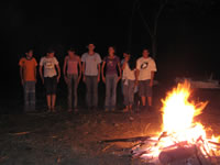 Teenagers from the Eco Club singing by the campfire