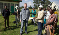 David Fox handing over NGO books for conservation