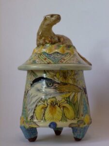 Ceramic lidded pot with an otter on the top of the lid