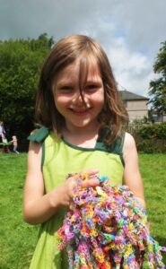 Holly holds a bundle of loom bands.