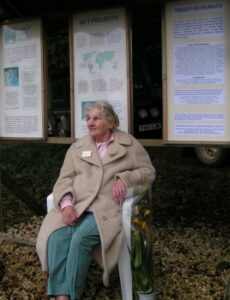 Jane Pointer sitting in front of display boards at Kites Hill.