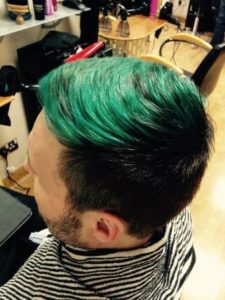 A view of Steve's hair dyed forest green.