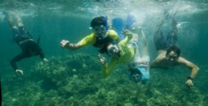 Marine camp schoolchildren and volunteers underwater at Danjugan island. Credit Toby Gibson