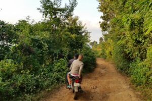 Cycling up the mud track in Garo Hills. Image: Camilla and Julian Read