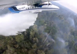 A small plane dropping water on fires in Guatemala. Credit: FUNDAECO