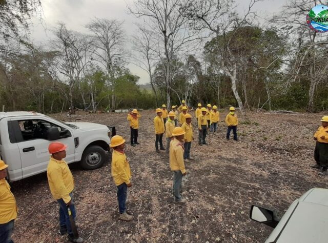 Image of a fire fighting team in Guatemala, gathering for a socially distanced briefing.