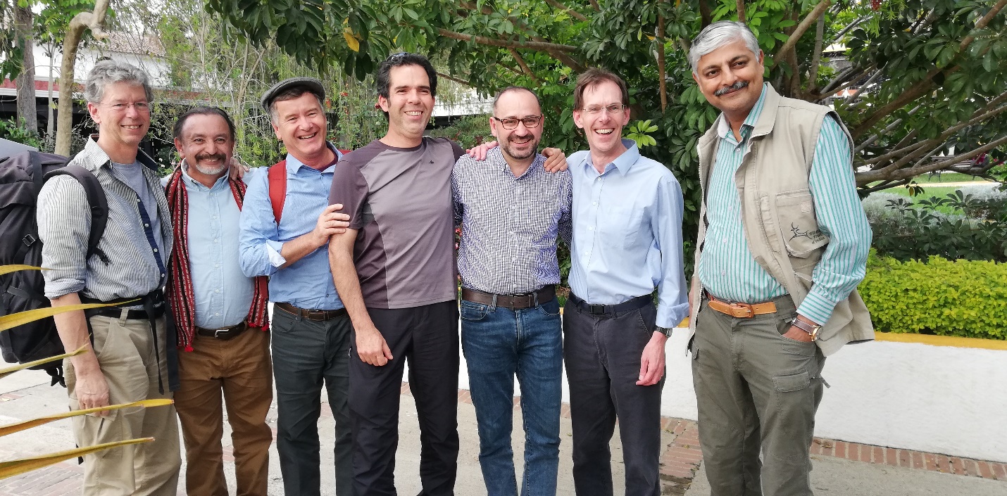 Dr Jonathan Barnard stands shoulder to shoulder with six conservation colleagues representing six WLT partners.