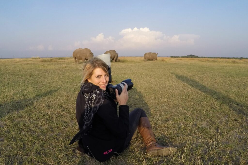 Chantelle Melzer photographing the last two Northern White Rhinos with a Southern White Rhino in Ol Pejeta Conservancy, Kenya. Credit: Shane Raw