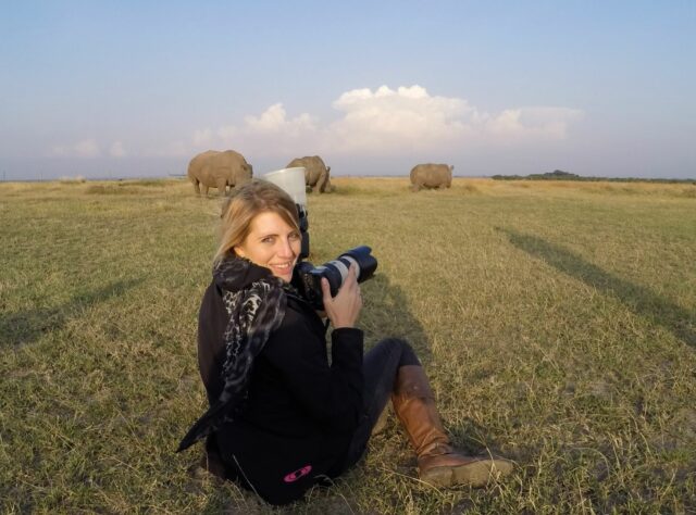 Chantelle Melzer photographing the last two Northern White Rhinos with a Southern White Rhino in Ol Pejeta Conservancy, Kenya. Credit: Shane Raw