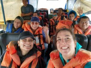 Photo of Mary and NCE team with lifejackets travelling upriver.