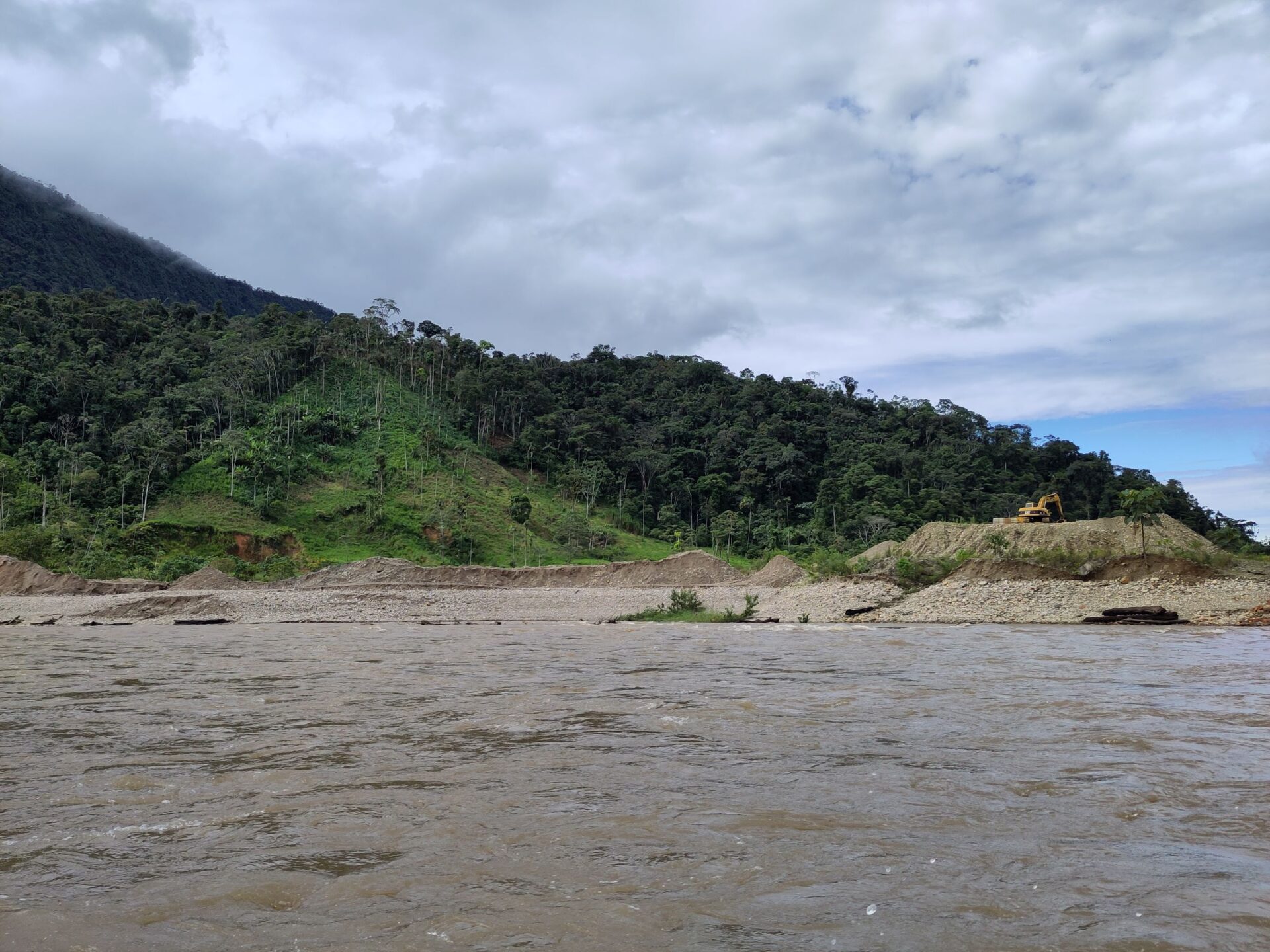 This photo shows the two main threats present in this part of Ecuador: illegal gold mining and deforestation for pasture, in the typical triangular shape. Credit: Mary McEvoy 