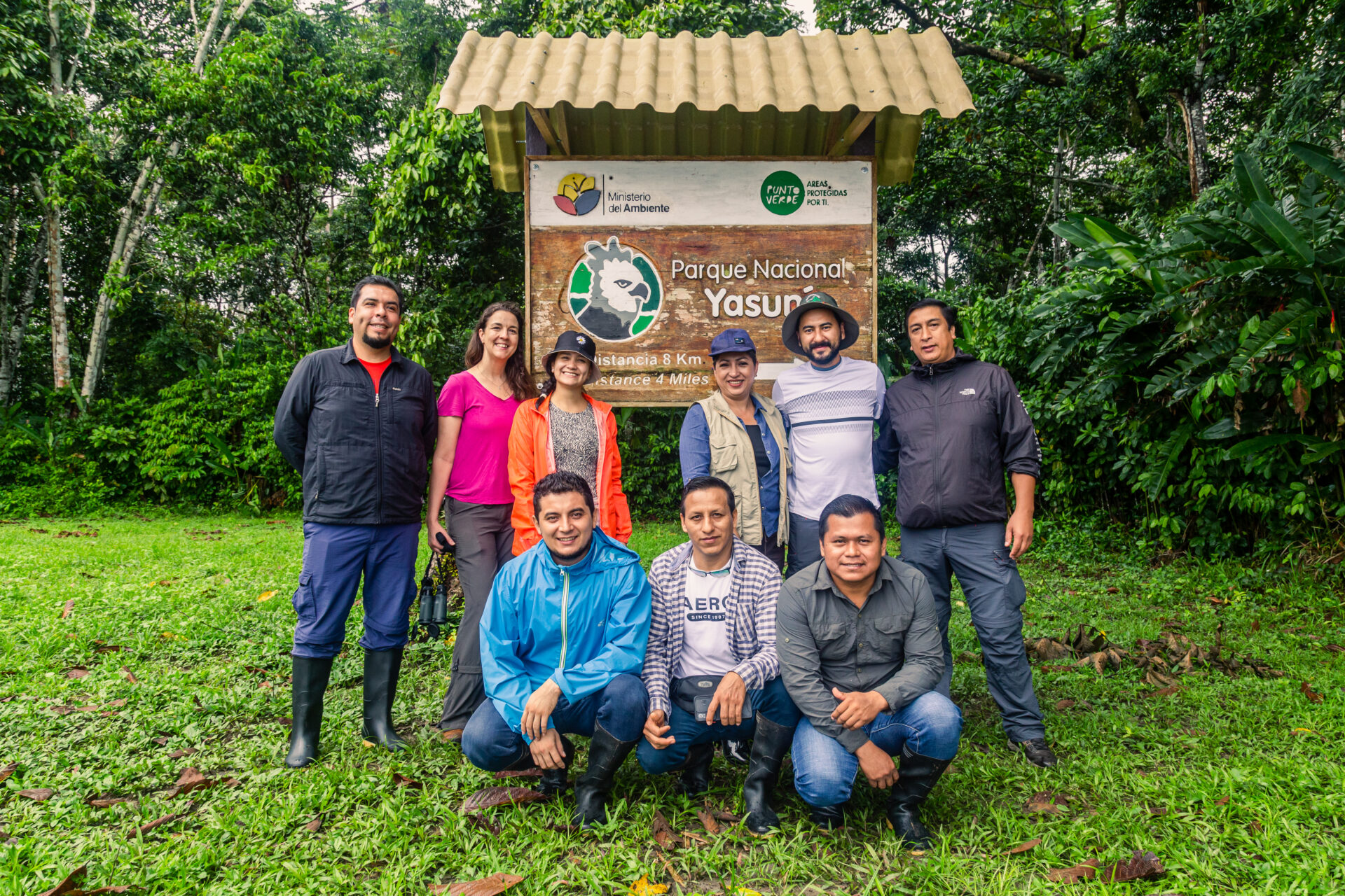 Jaime and a group of his colleagues standing in front of the sign for Yascuni Park in the Ecuadorian Amazon rainforest. 