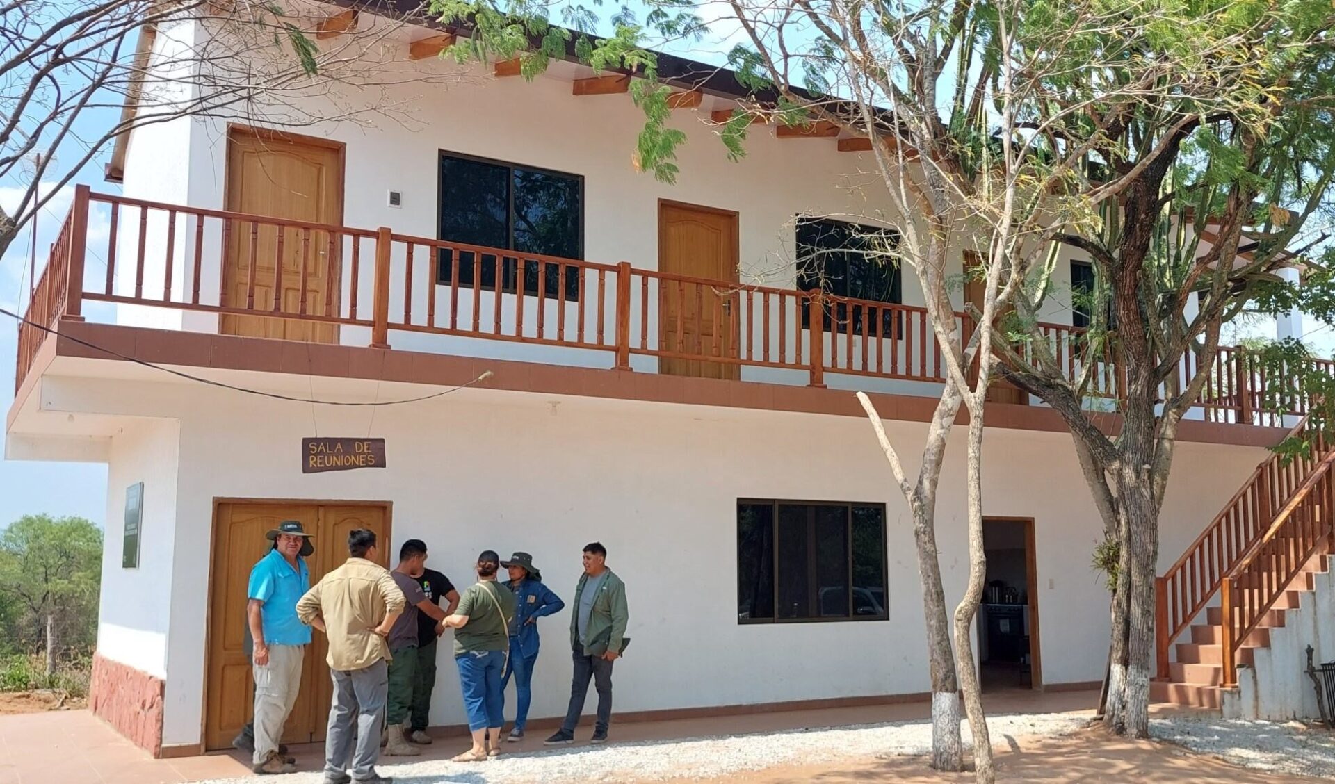 Group of people standing in front of Ñembi Guasu's operational base. 