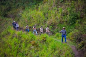 team of rangers and community members walking through the lush forests of Honduras.