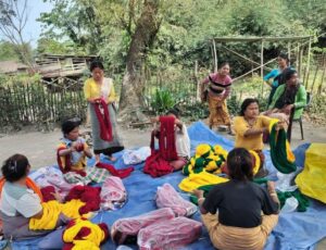 A photo of yarn being distributed to women at one of the villages WTI works with.
