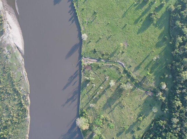 An aerial photograph of the Magdalena River and the manmade canal cutting a damaging route from it towards the Barbacoas Wetlands.