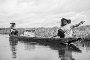 Two fishermen on a boat within the Barbacoas wetlands