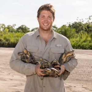 Freshwater turtle biologist Pearson McGovern holding young Magdalena River Turtles