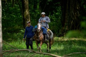 A photo of Noel Torres on horseback in the field.