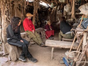 A photograph of Nicolasa Bazan with members of the Natura Argentina team in her home in the mountains of the Sierra de Ambato.