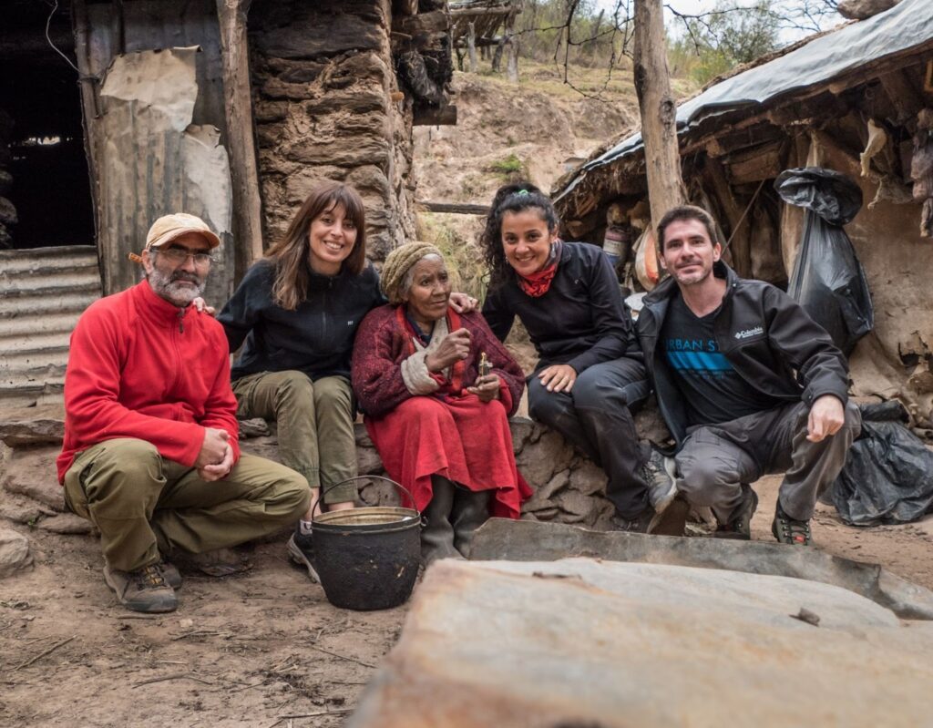 A photograph of Nicolasa Bazan and members of the Natura Argentina team outside her home in the Sierra de Ambato