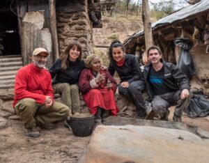A photograph of Nicolasa Bazan and members of the Natura Argentina team outside her home in the Sierra de Ambato