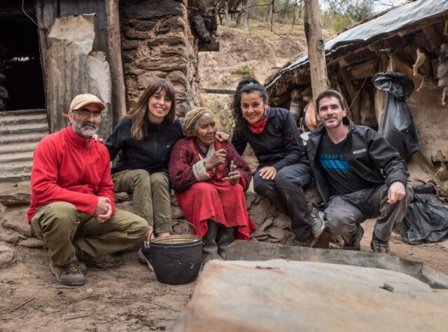 A photograph of Nicolasa Bazan and members of the Natura Argentina team outside her home in the Sierra de Ambato