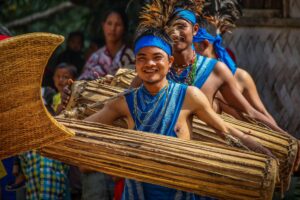 Photo of drummers at India's Wangala Festival, dressed in bright blue costumes.