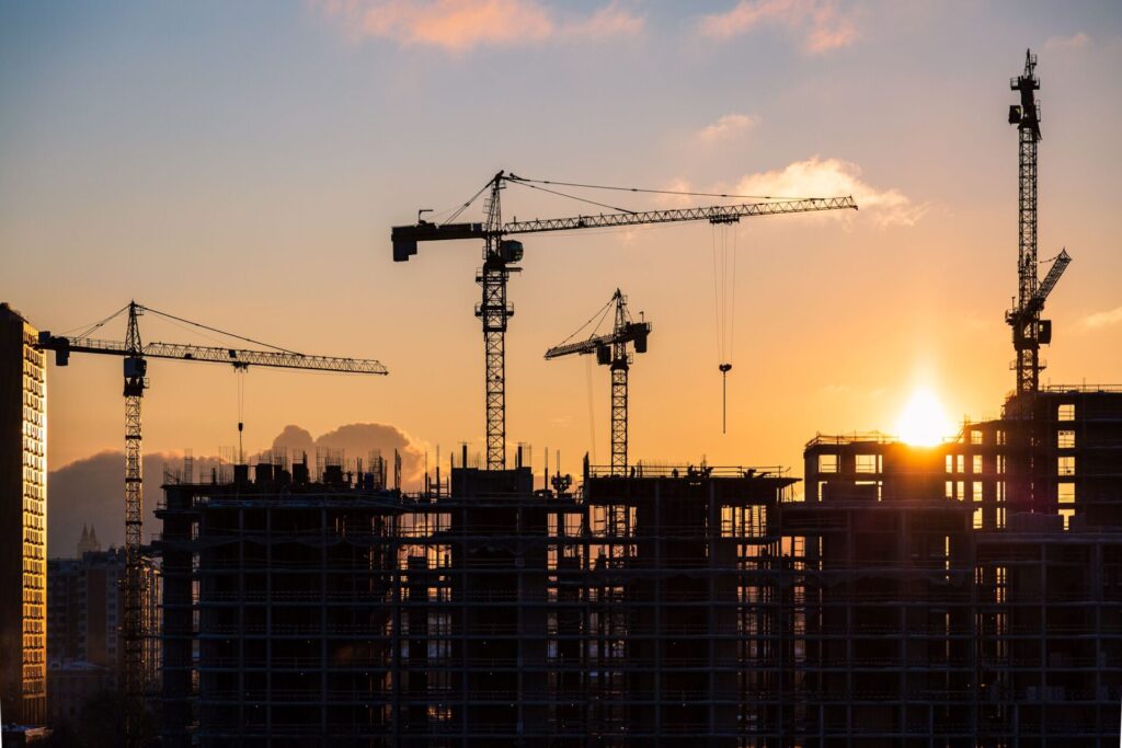 Cranes on a building site at sunset